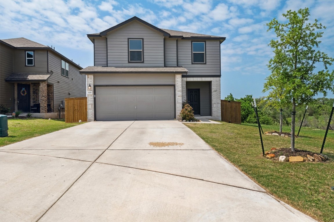 925 Yellow Ribbon Trail Jarrell, TX 76537 - Photo 1 of 35 a front view of a house with a garden