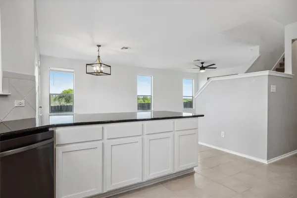 a kitchen with a refrigerator and cabinets