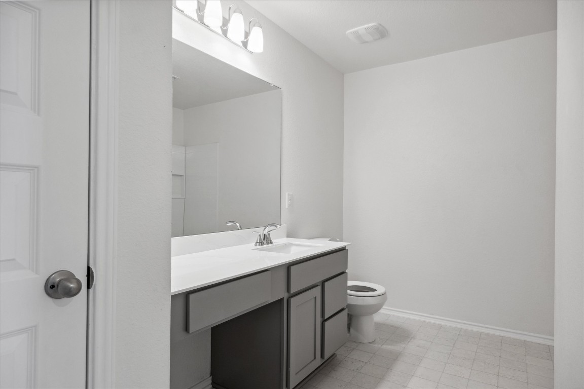 925 Yellow Ribbon Trail Jarrell, TX 76537 - Photo 16 of 35 a bathroom with a sink a toilet a mirror and shower