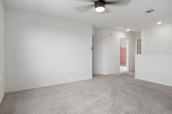 an empty room with windows and closet
