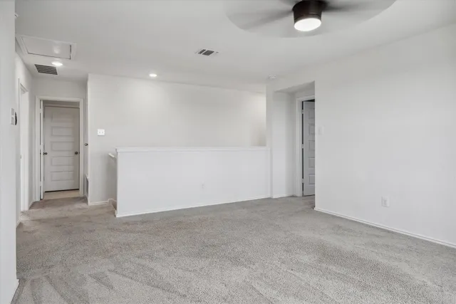 a view of a room with a ceiling fan