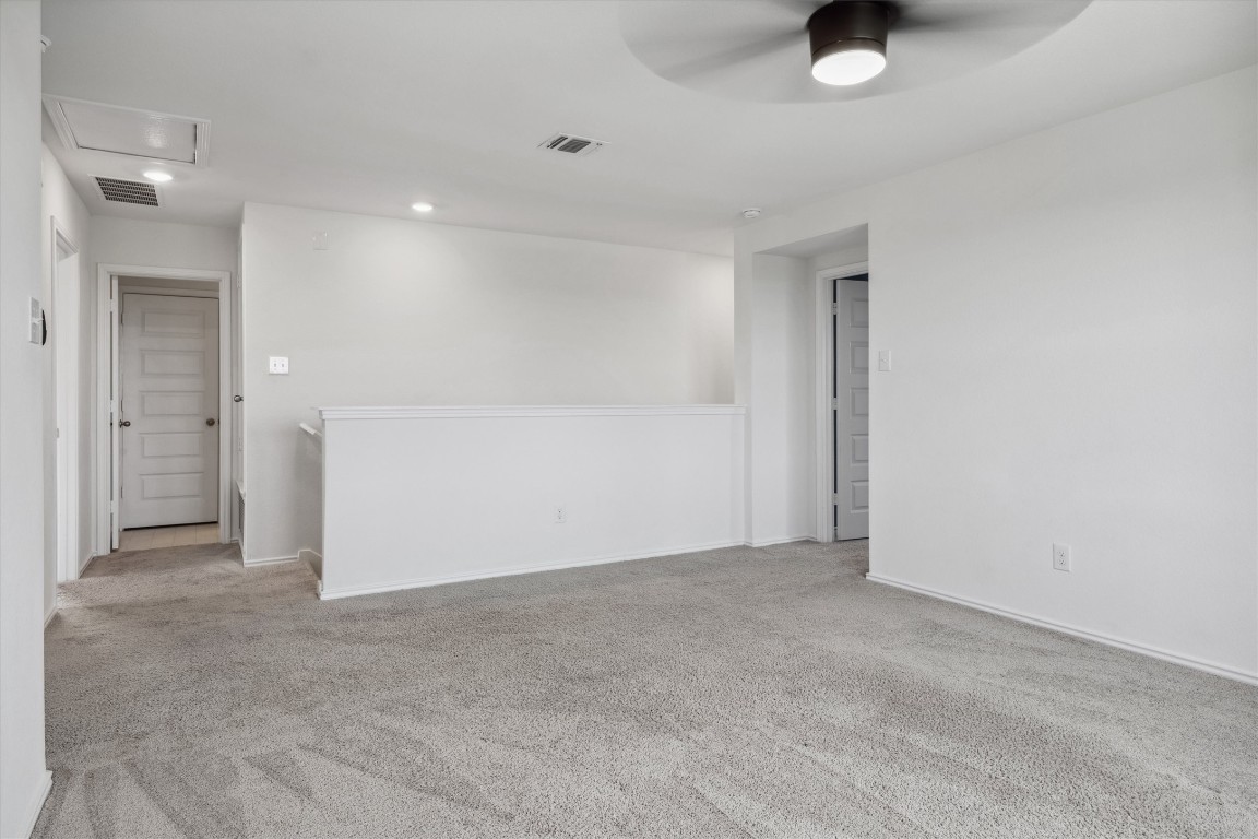 925 Yellow Ribbon Trail Jarrell, TX 76537 - Photo 21 of 35 an empty room with a ceiling fan and mirror