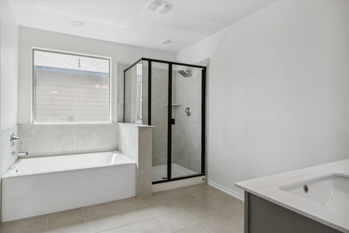 925 Yellow Ribbon Trail Jarrell, TX 76537 - Photo 26 of 35 a bathroom with a bathtub and a shower
