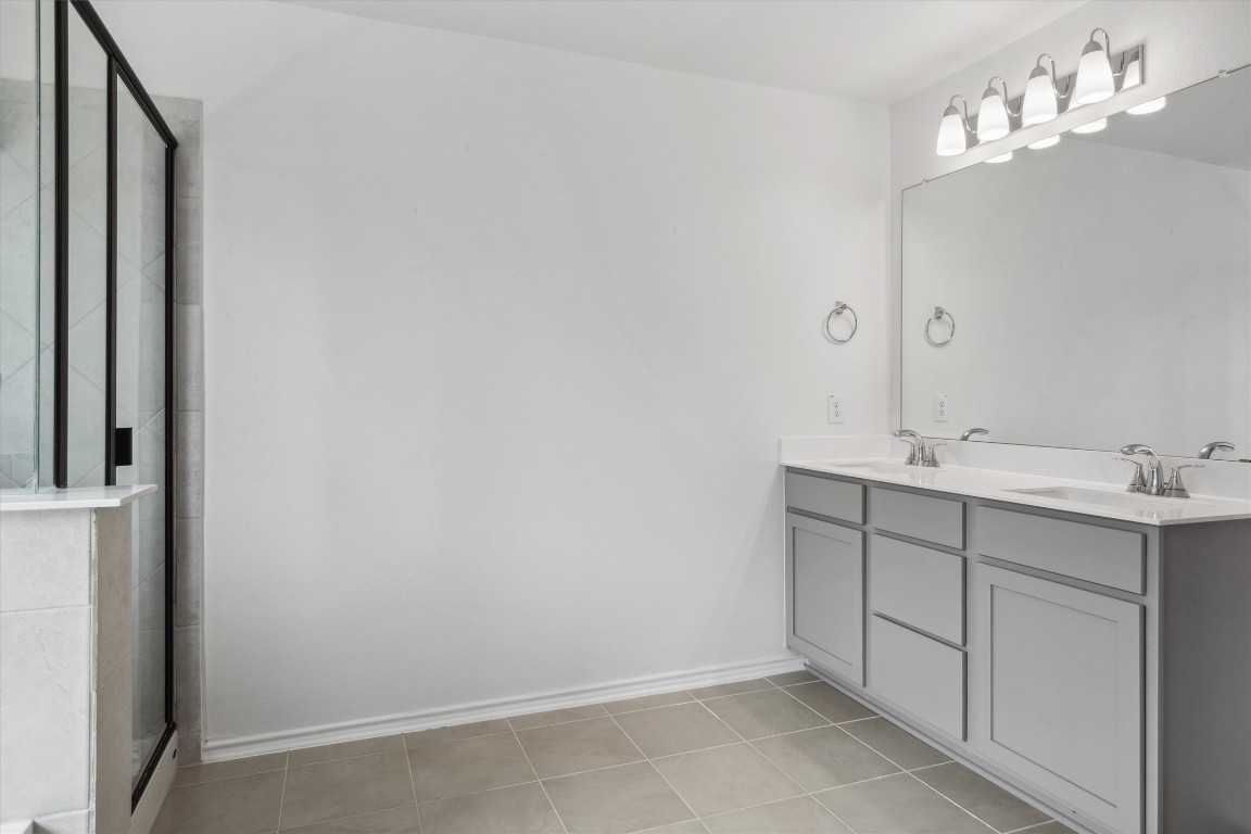 925 Yellow Ribbon Trail Jarrell, TX 76537 - Photo 28 of 35 a bathroom with a sink vanity and mirror