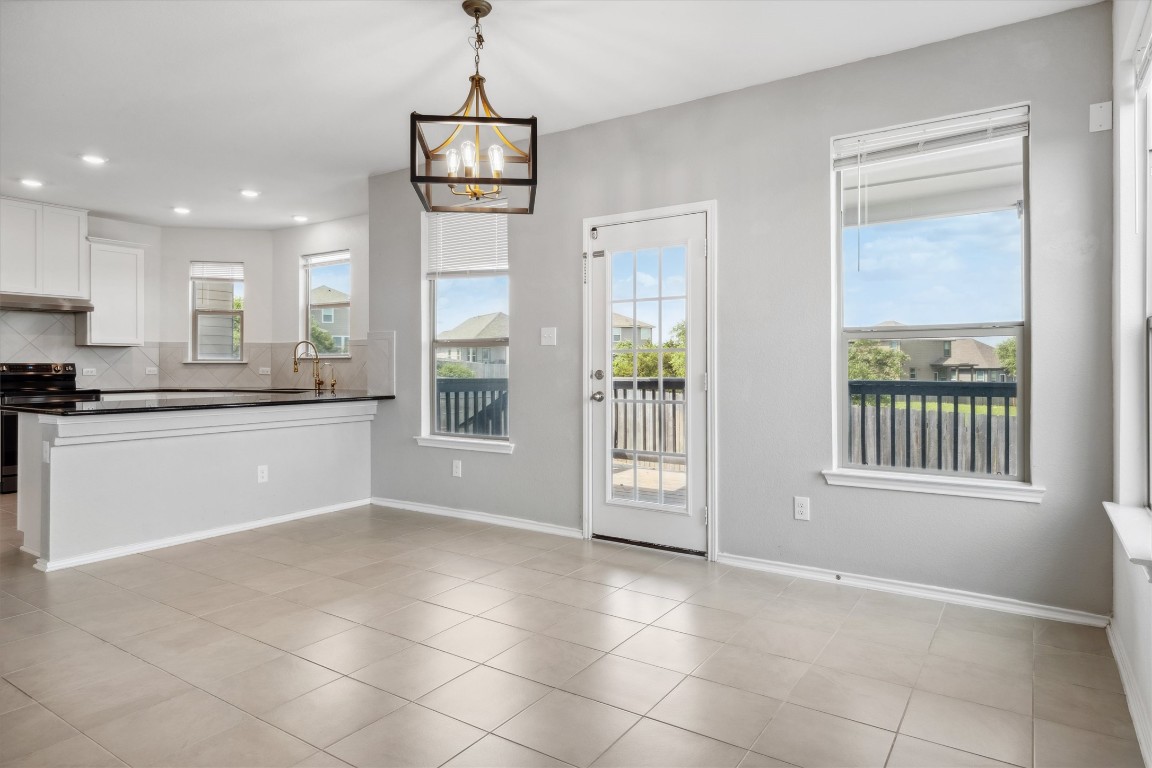 925 Yellow Ribbon Trail Jarrell, TX 76537 - Photo 6 of 35 a kitchen with stainless steel appliances granite countertop a stove a sink a refrigerator a microwave a counter top and cabinets