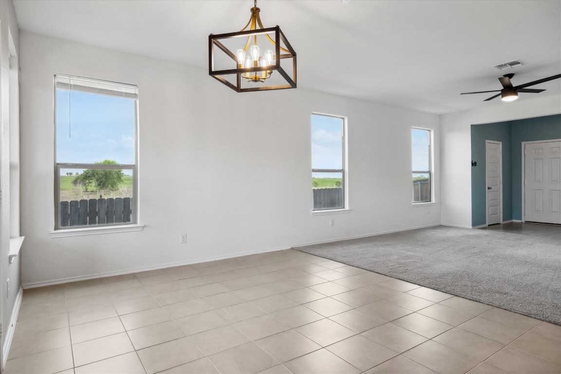 925 Yellow Ribbon Trail Jarrell, TX 76537 - Photo 7 of 35 an empty room with windows and ceiling fan