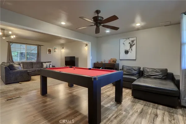 a living room with furniture a rug and a chandelier