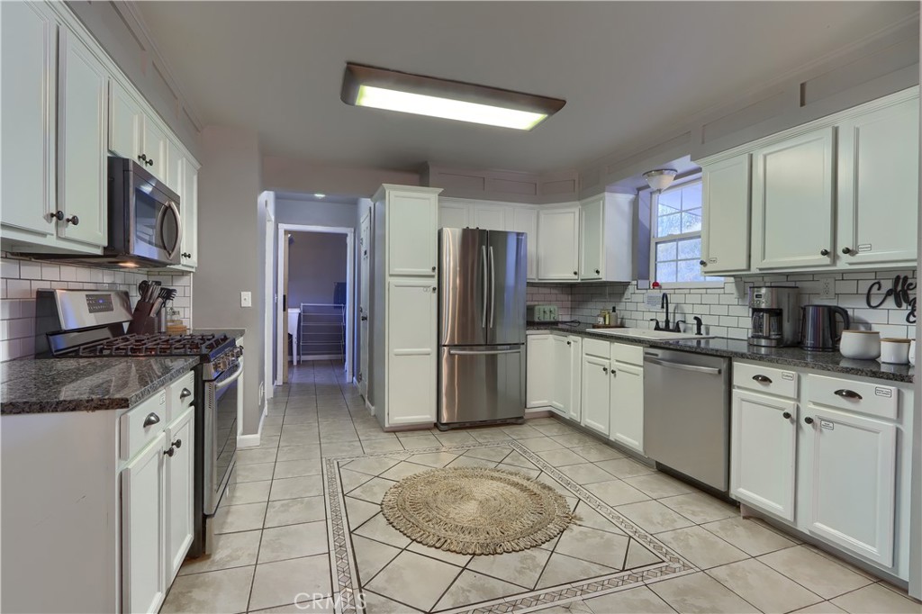 5197 Colorado Road Midpines, CA 95345 - Photo 17 of 47 a kitchen with stainless steel appliances granite countertop a stove a sink and a refrigerator
