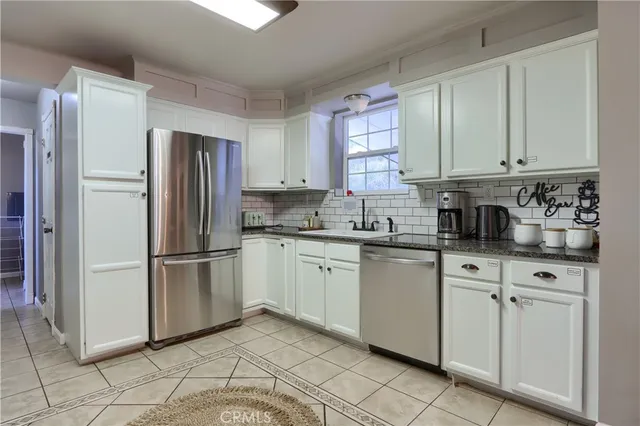 a kitchen with appliances cabinets and a sink