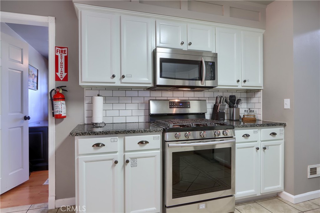 5197 Colorado Road Midpines, CA 95345 - Photo 19 of 47 a kitchen with cabinets stainless steel appliances and a sink