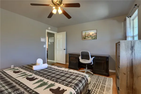 a bedroom with a bed and a chair