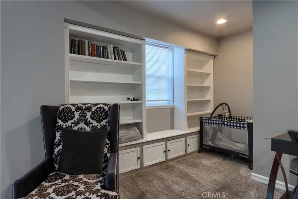 a bedroom with furniture and a window