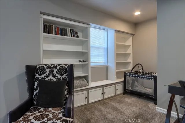a bedroom with furniture and a window