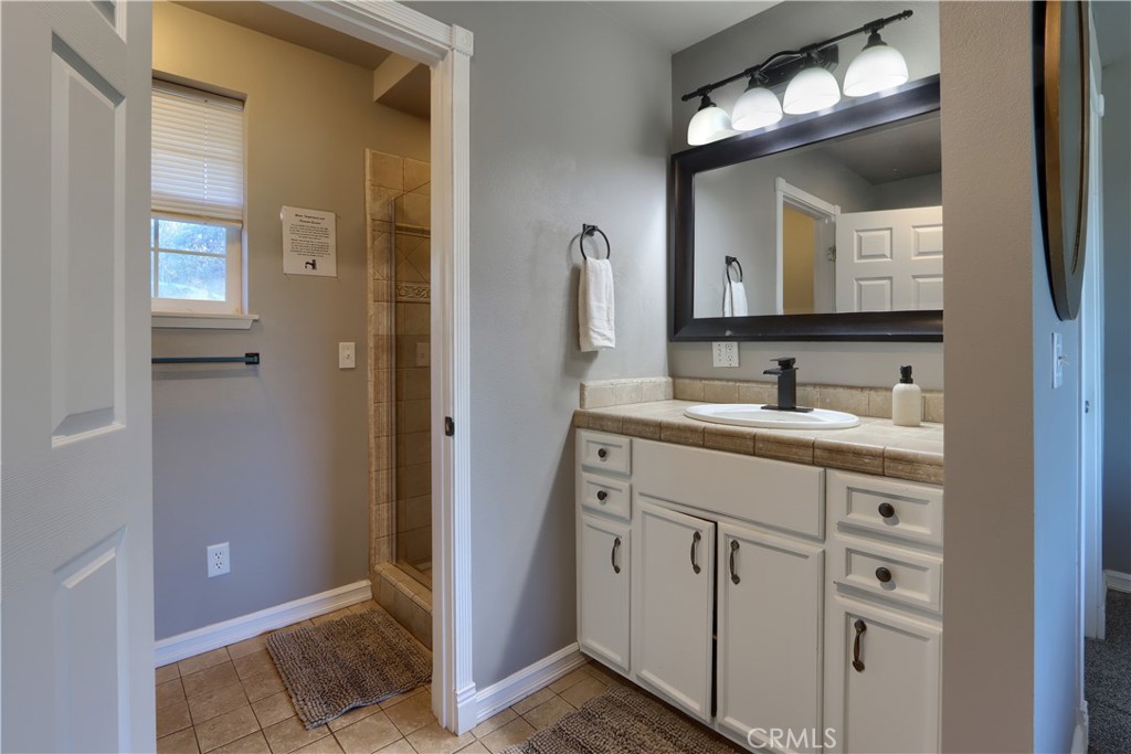 5197 Colorado Road Midpines, CA 95345 - Photo 31 of 47 a bathroom with a double vanity sink and a mirror