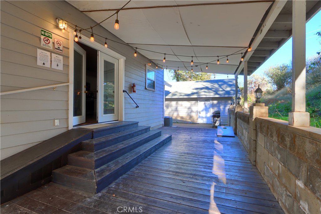 5197 Colorado Road Midpines, CA 95345 - Photo 36 of 47 a view of a porch with wooden floor and outdoor seating