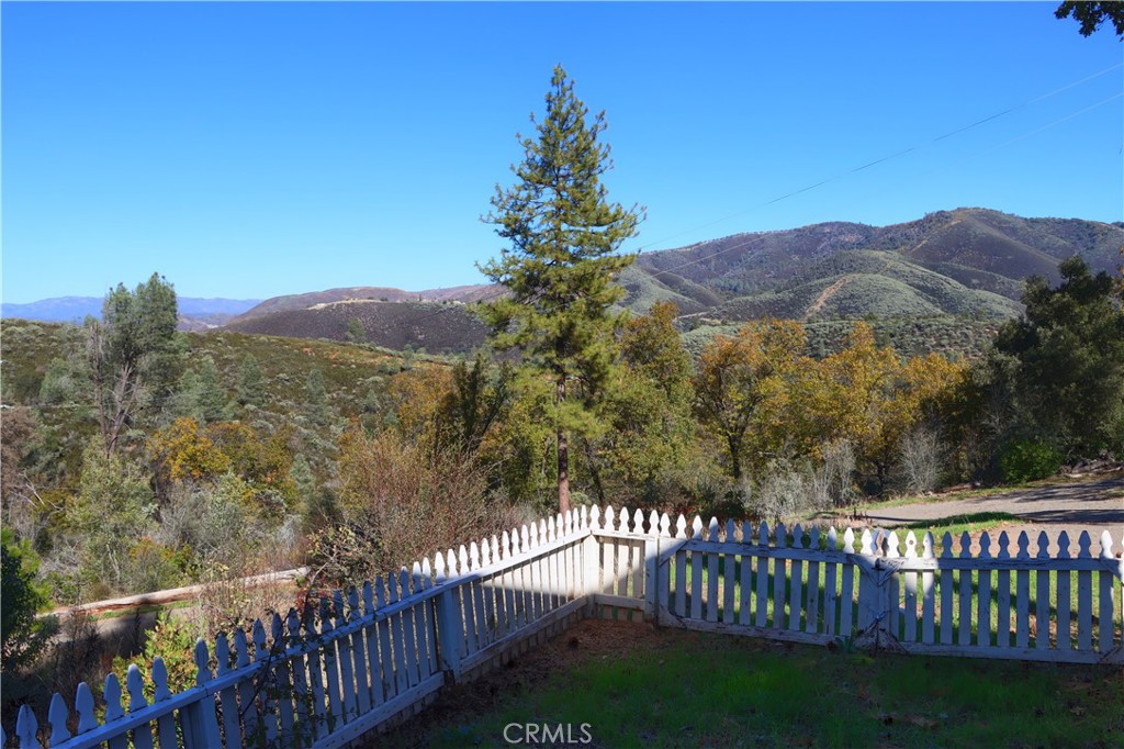 5197 Colorado Road Midpines, CA 95345 - Photo 5 of 47 a view of a lush green hillside and a forest