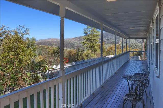 a view of a porch with furniture and wooden floor