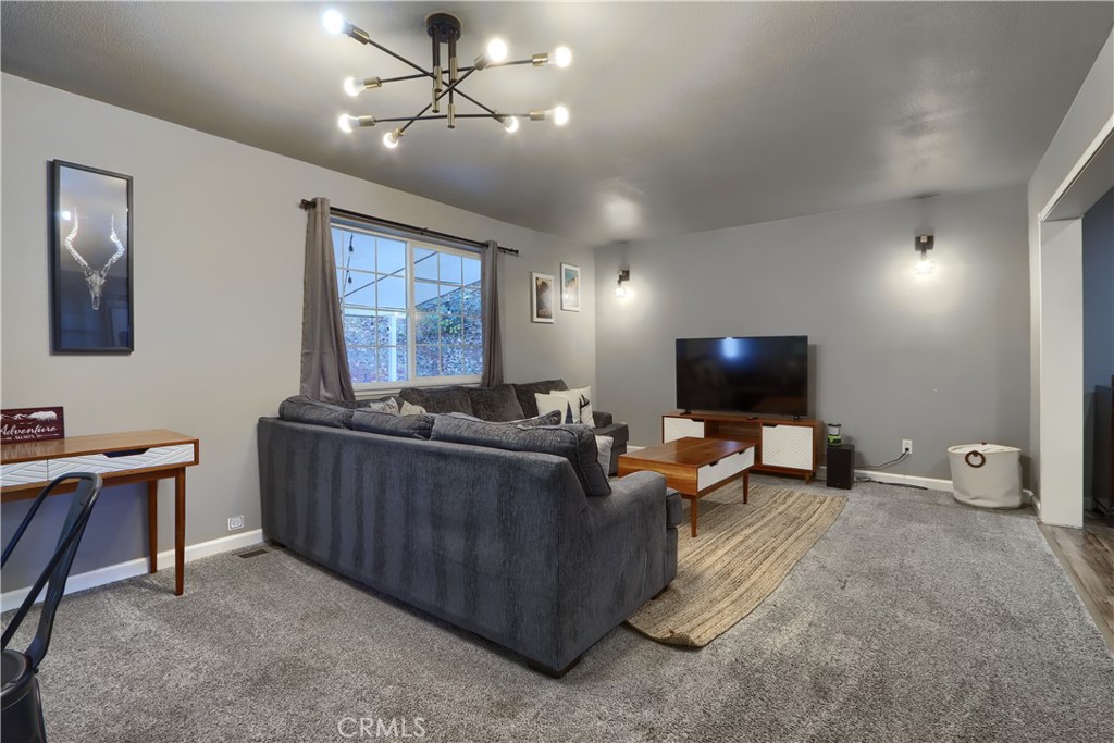 5197 Colorado Road Midpines, CA 95345 - Photo 9 of 47 a living room with furniture a flat screen tv and a window