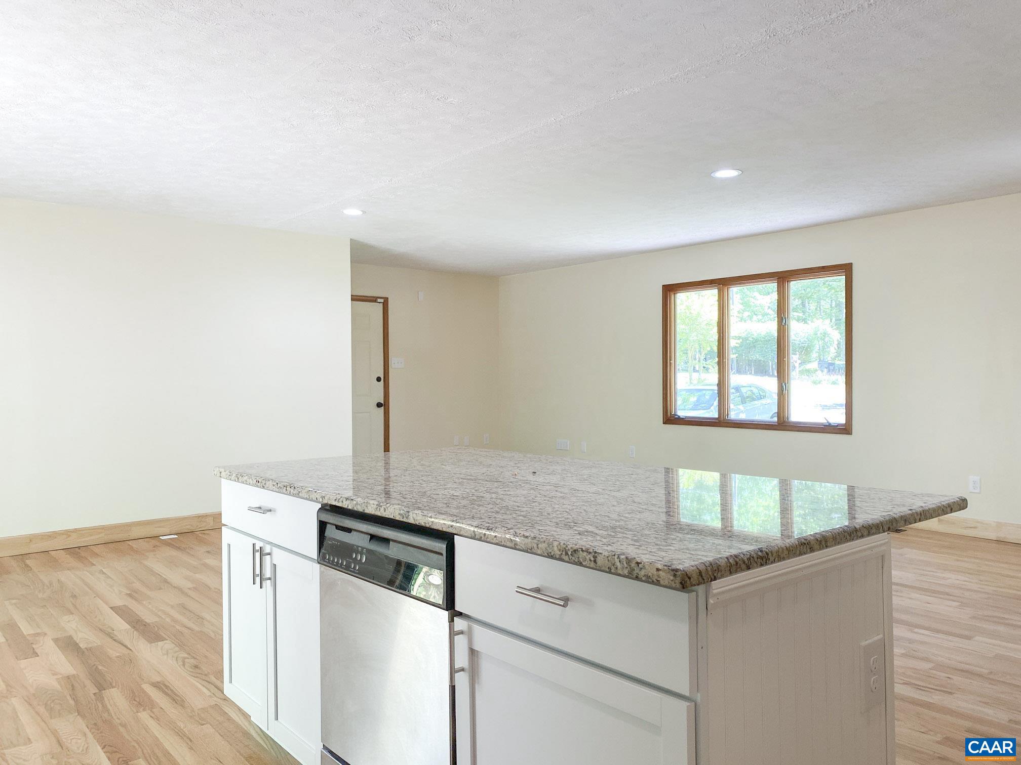 247 Goldenrod Road Ruckersville, VA 22968 - Photo 10 of 35 a kitchen with granite countertop white cabinets and white appliances