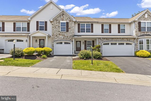 a front view of a house with a yard and a garage