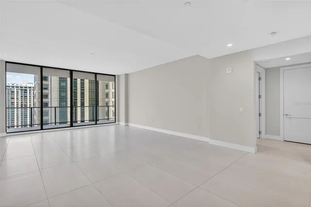 a view of staircase with railing and white walls