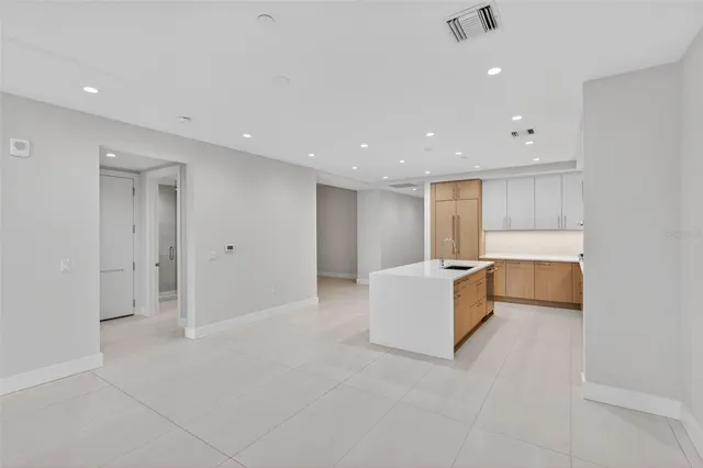 a kitchen that has a sink a stove and cabinets