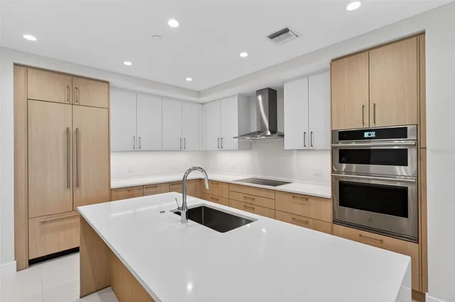 a kitchen with sink cabinets and stainless steel appliances