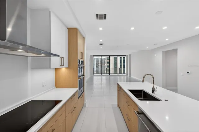a kitchen with a sink window and cabinets