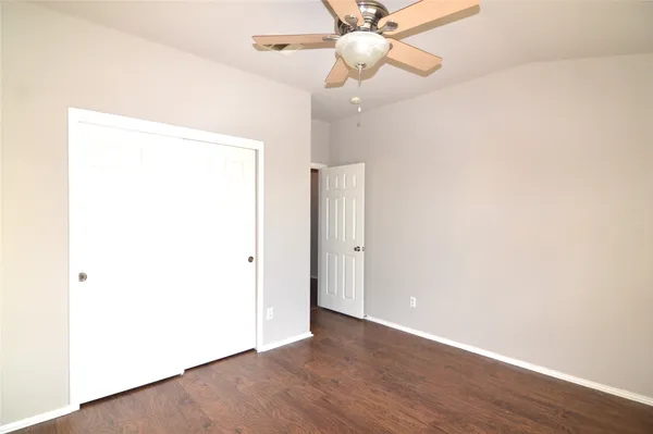 a view of a house with a big yard and large tree