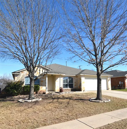 a front view of a house with yard and seating space