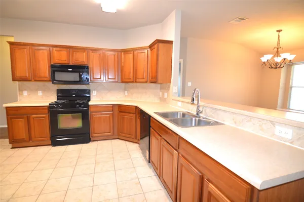 a kitchen with stainless steel appliances a stove sink and cabinets