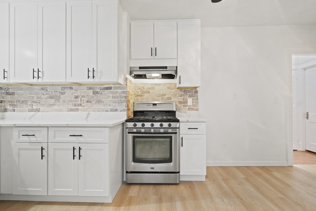 31 Madison Street Lynn, MA 01902 - Photo 11 of 30 a kitchen with white cabinets and white appliances