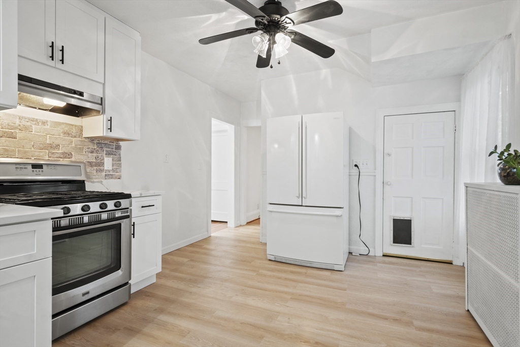 31 Madison Street Lynn, MA 01902 - Photo 12 of 30 a kitchen with stainless steel appliances a stove a refrigerator and a microwave