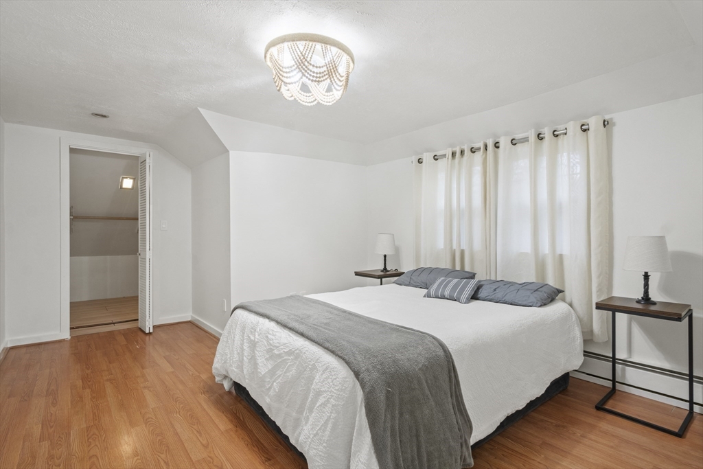 31 Madison Street Lynn, MA 01902 - Photo 19 of 30 a bedroom with a bed and a chandelier