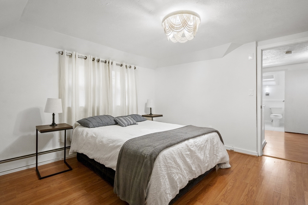 31 Madison Street Lynn, MA 01902 - Photo 20 of 30 a bedroom with a bed and a chandelier