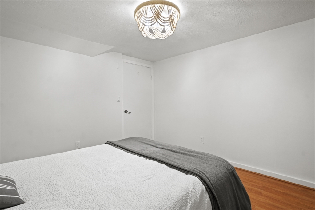 31 Madison Street Lynn, MA 01902 - Photo 21 of 30 a bedroom with a bed and a window