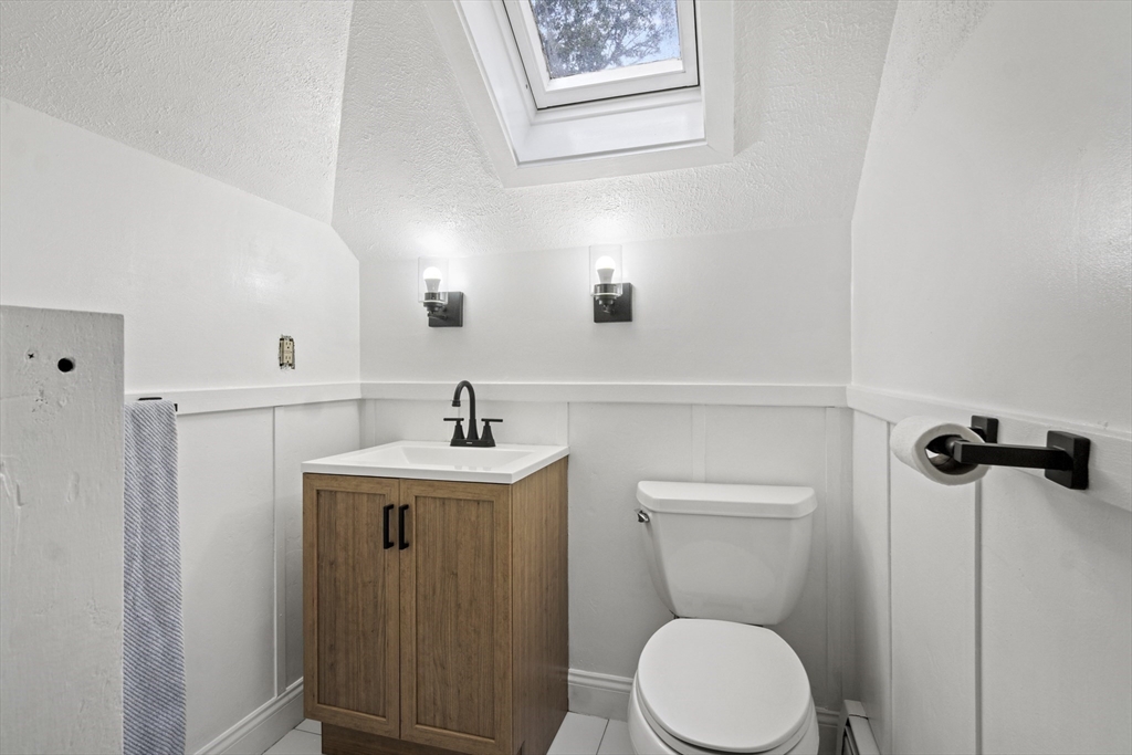 31 Madison Street Lynn, MA 01902 - Photo 23 of 30 a bathroom with a toilet a sink and mirror