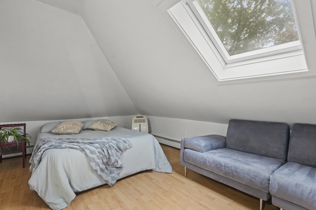 31 Madison Street Lynn, MA 01902 - Photo 24 of 30 a bedroom with a bed couch and a window