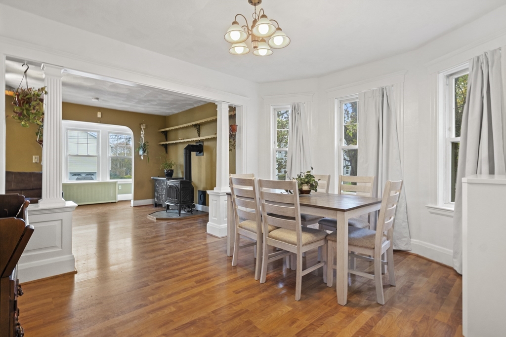 31 Madison Street Lynn, MA 01902 - Photo 6 of 30 a dining room with wooden floor a chandelier a wooden table and chairs