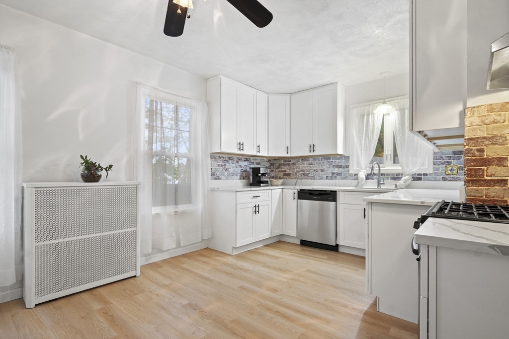 31 Madison Street Lynn, MA 01902 - Photo 9 of 30 a kitchen with white cabinets appliances and a window