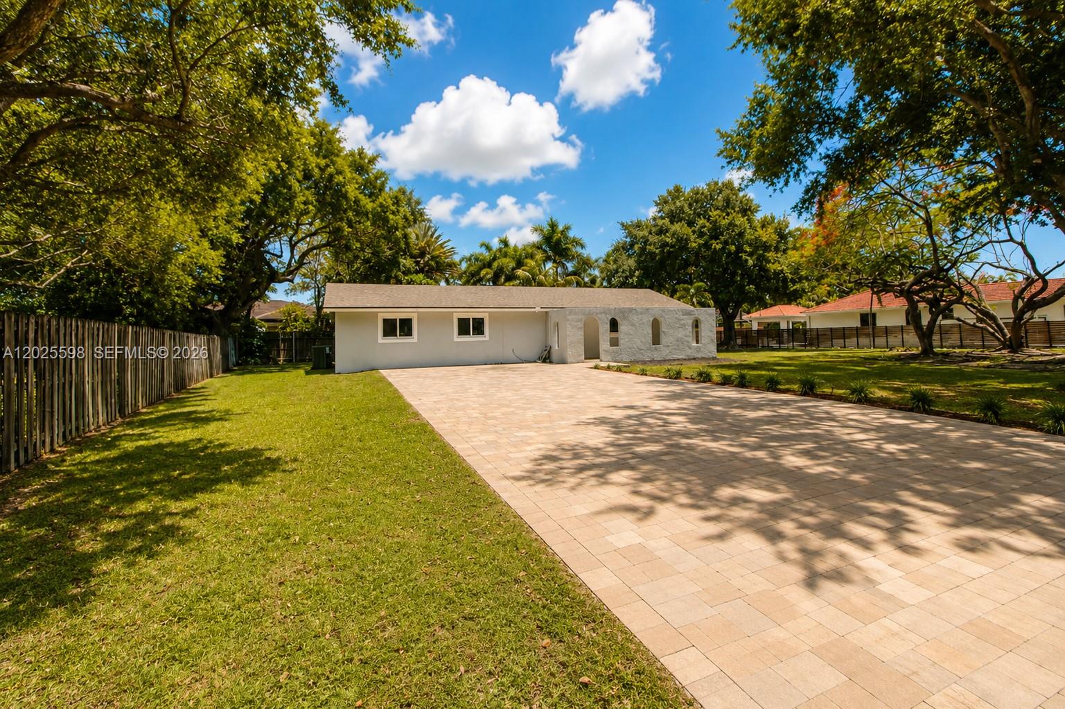 9421 Southwest 150th Street Miami, FL 33176 - Photo 2 of 31 a view of a house with a yard