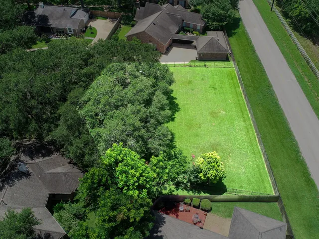 an aerial view of residential houses with outdoor space and street view