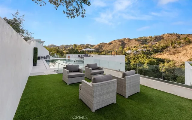 a view of a chairs and table in backyard