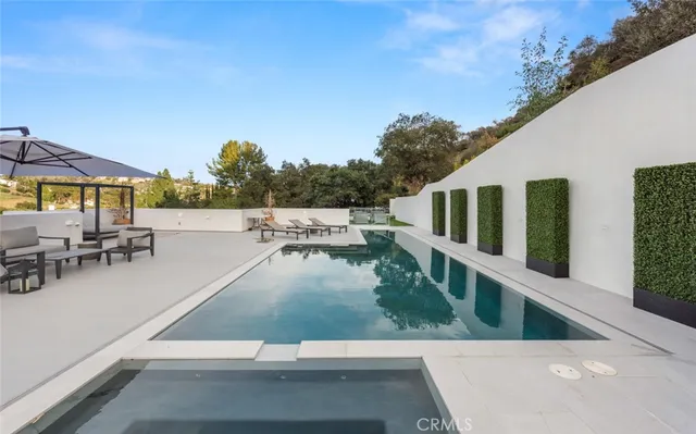 a large white bathroom with a double vanity sink and a mirror