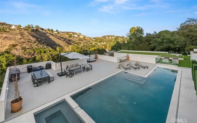 a large kitchen with stainless steel appliances kitchen island granite countertop a refrigerator and a stove top oven