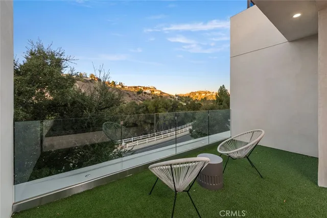 a view of a balcony with chairs