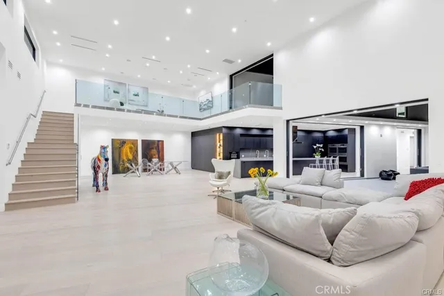 a kitchen with kitchen island a sink appliances and cabinets