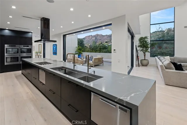 a kitchen with a sink and chairs