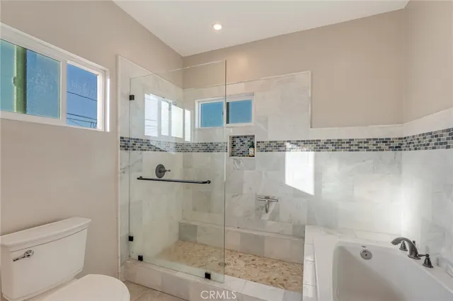 a bathroom with a glass shower door