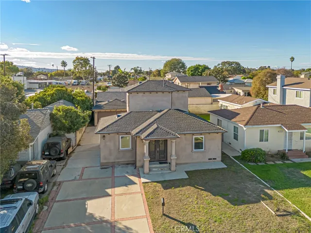 an aerial view of residential houses with outdoor space